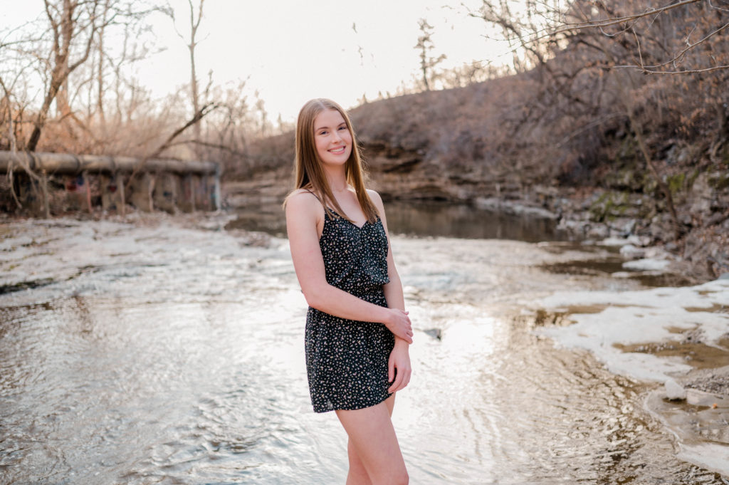 senior photo in a creek
