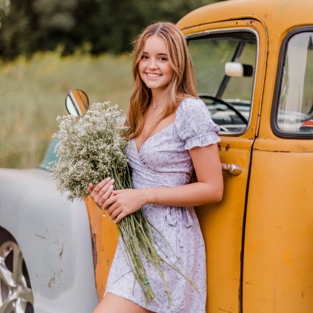 Senior picture with old truck and flowers