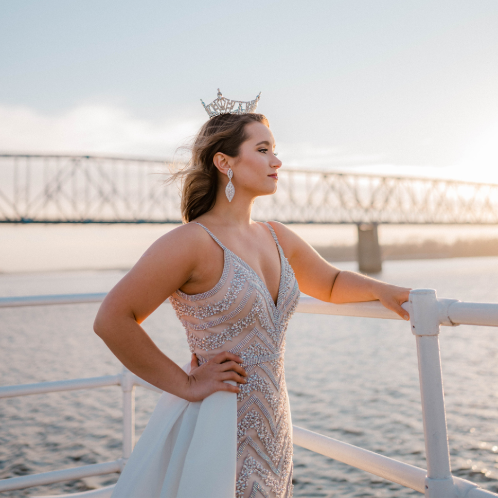 Portrait image of a pageant queen by the riverfront
